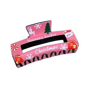 Pink large Christmas shark hair claw clip with festive patterns of trees and bears