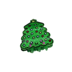 Sparkly green Christmas tree hair claw clip with colorful polka dots and star topper