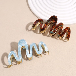 Elegant wave-shaped acetate shark hair clips in tortoiseshell and blue marble finish
