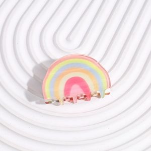 Detailed macro view of a glittery translucent acrylic rainbow hair claw clip