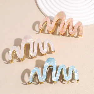 French wavy acetate shark clips in iridescent pink, pearl white, and marble blue finishes