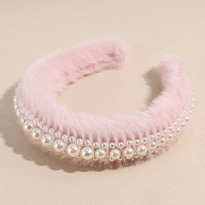 Close-up of pink fluffy headband featuring multi-layered pearls and thick sponge texture
