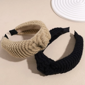 Thick knitted headband in khaki and black colors with classic cable knit texture pattern