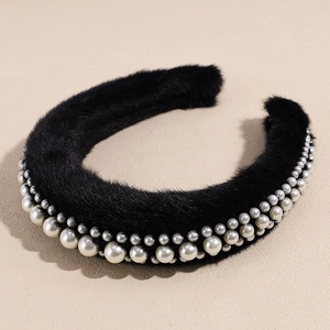 Close-up of black plush headband with three rows of elegant white pearls