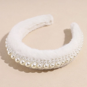 Close-up of cream faux fur headband featuring double-layered pearl embellishments