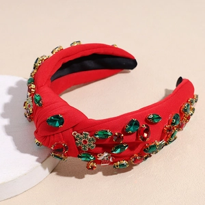 Detailaufnahme rotes Knotenstirnband mit Strasssteinen und Weihnachtsanhängern