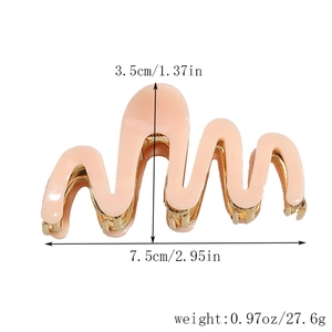 Macro view of light pink wavy acetate hair claw with gold metal teeth and 7.5cm size