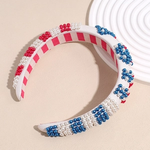 Detail of sponge headband with red, white and blue beads on a textured fabric