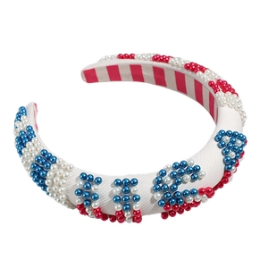 Padded white sponge headband with red white and blue pearls forming USA letters