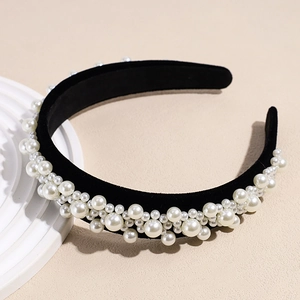 Detail of vintage baroque headband with white faux pearls on black velvet base