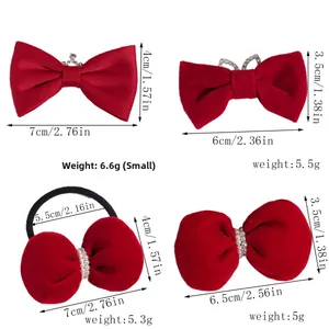 Detail view of four mini red velvet bow hair clips with crown and pearl decorations