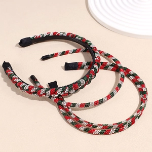Three Christmas headbands with red, green, and white rhinestones in a festive spiral pattern