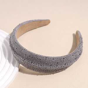 Close-up of grey velvet headband with hand-beaded rhinestones and non-slip lining