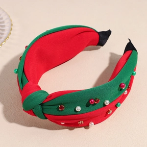 Detail of red and green knotted headband with pearls and rhinestones for Christmas