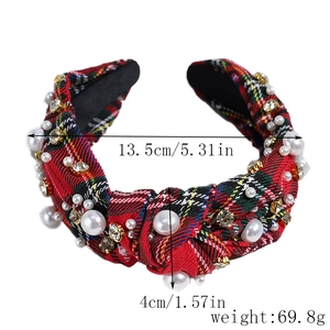 Detail showing red tartan headband with white faux pearls and rhinestone embellishments