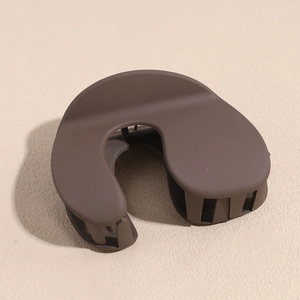 Detail view of the matte dark coffee U-shaped shark hair clip with strong inner teeth