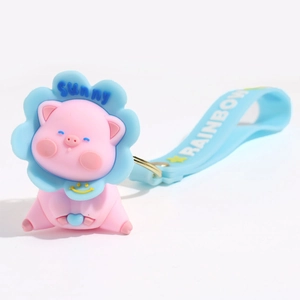 Cute pink cartoon pig keychain with a light blue sunflower collar and rainbow wrist strap