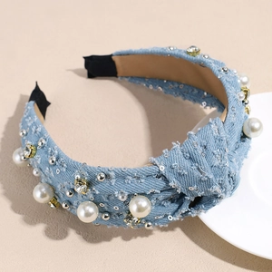 Detail of blue denim headband with knotted design, faux pearls and sparkling rhinestones