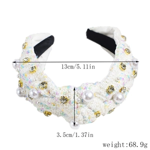 Detail view of white tweed headband with embedded pearls and sparkling rhinestones