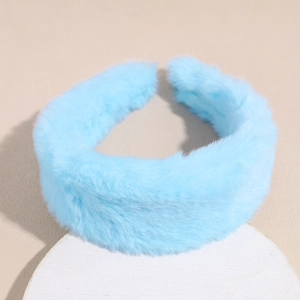 Close-up of thick light blue plush headband with soft faux fur texture for women