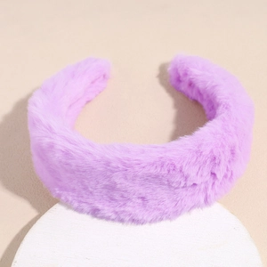 Close-up of a thick purple plush headband with soft faux fur texture and wide design