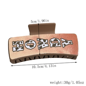 Detailed size chart showing a 10.5cm orange HONEY hair claw clip with cow print details