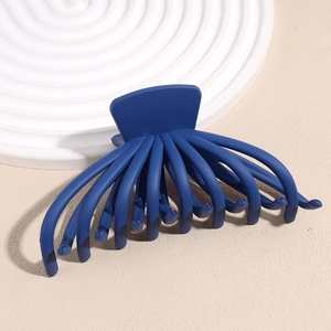 Macro shot of dark blue matte octopus hair claw clip with multi-tooth design details