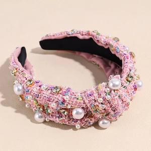 Detailed view of pink tweed headband featuring white pearls and sparkling rhinestones