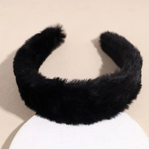 Close-up of thick black plush headband with soft faux fur texture on a white stand