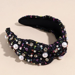 Detail of tweed fabric texture with faux pearls and rhinestones on the padded headband