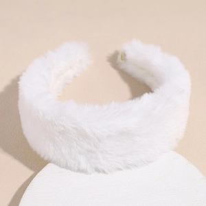 Close-up of white plush headband with soft faux rabbit fur texture and thick design