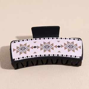 Detail view of large rectangular hair claw clip with bohemian geometric pattern on pink faux leather