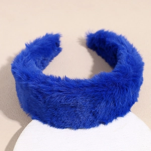 Macro shot of thick cobalt blue plush headband texture on a minimalist display stand