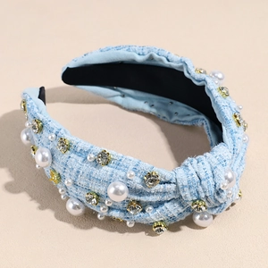 Detail of light blue tweed headband with knotted design, faux pearls and crystals