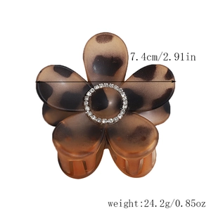 Detail of leopard print flower hair claw with rhinestones and size marking 7.4cm
