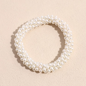 Close-up of a premium white pearl elastic hair ring with intricate woven bead details