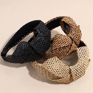 Three Bohemian raffia woven headbands in black, coffee, and beige with top knot detail