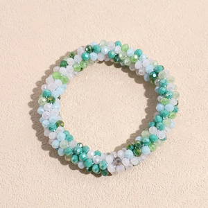 Macro shot of mint green and milky white beaded elastic hair tie with faceted beads
