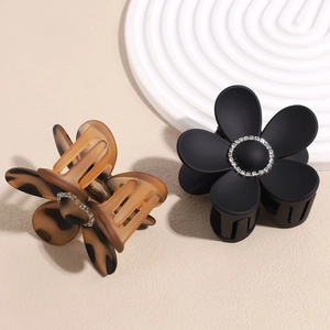 Sparkling rhinestone flower hair claw clips in matte black and amber leopard patterns