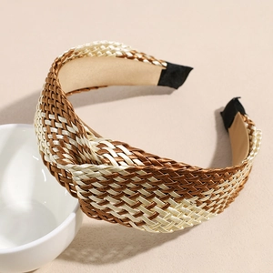 Detail of bohemian twisted woven headband in dark brown, champagne, and cream satin material