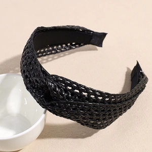 Detail of bohemian black woven headband featuring a stylish knot and textured straw pattern