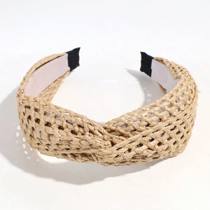 Detailed macro view of Bohemian straw woven cross knot headband with protective black fabric tips