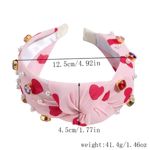 Detail of pink knotted headband with heart patterns, rhinestones and pearls measurements