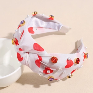 Detail of heart print knotted headband with pearls and colorful rhinestone embellishments
