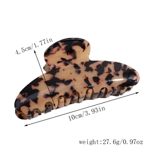 Detail view of tortoiseshell acetate hair claw clip with France Handmade text label