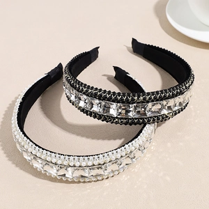Luxury baroque padded headbands with crystal rhinestones and pearls on a sand background