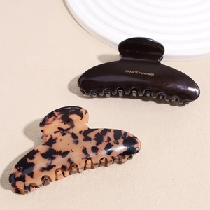 French style tortoise shell and dark brown acetate hair claw clips with gold logo