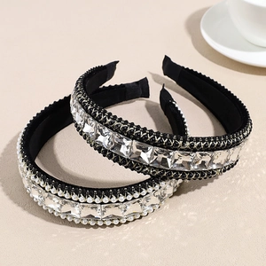 Baroque black headband set with crystals and pearls on beige background