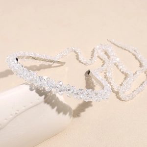 Detail of crystal braided headband with long tassels and sparkling silver metal frame