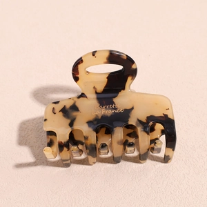 Close-up of vintage tortoiseshell acetate hair claw with Barrette La France gold stamp